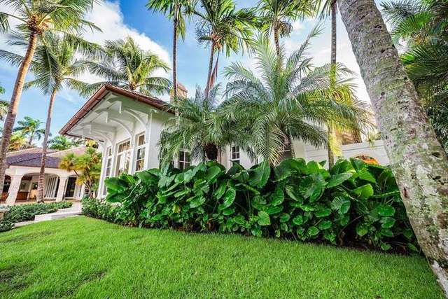 Waterfront estate with palm trees, pool, and professional landscape company work in Manalapan, FL – Perfect Cut Landscaping